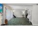 Bright living room featuring stone accent wall, tile flooring, and a light neutral color scheme at 6140 Sun Blvd # 7, St Petersburg, FL 33715