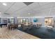 Spacious recreation room with tables, chairs, TV, pool table, and views of the community at 6140 Sun Blvd # 7, St Petersburg, FL 33715
