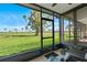 A screened porch overlooking a lush green golf course on a clear, sunny day at 6140 Sun Blvd # 7, St Petersburg, FL 33715