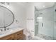Bathroom featuring walk-in shower, vanity with modern fixtures and a large mirror at 6727 Burlington N Ave, St Petersburg, FL 33710