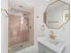Modern bathroom features a glass shower and a vanity with gold fixtures at 6727 Burlington N Ave, St Petersburg, FL 33710