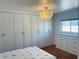 Bright bedroom featuring built-in wardrobe, drawers, and stunning statement light fixture, perfect for storage at 6727 Burlington N Ave, St Petersburg, FL 33710