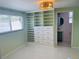 Stylish bedroom featuring built-in shelf and drawer unit with a window, and an ensuite bathroom at 6727 Burlington N Ave, St Petersburg, FL 33710