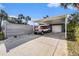Exterior view of carport with truck parked in driveway and palm trees at 6727 Burlington N Ave, St Petersburg, FL 33710