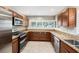 Updated kitchen boasts stainless steel appliances, granite countertops, tile backsplash, and custom cabinets at 6727 Burlington N Ave, St Petersburg, FL 33710
