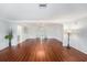 Spacious living room with gleaming wood floors, neutral paint, large windows and lots of natural light at 6727 Burlington N Ave, St Petersburg, FL 33710