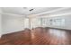 Spacious living room with gleaming wood floors, neutral paint, large windows and lots of natural light at 6727 Burlington N Ave, St Petersburg, FL 33710