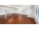Spacious living room with gleaming wood floors, neutral paint, large windows and lots of natural light at 6727 Burlington N Ave, St Petersburg, FL 33710