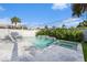 Outdoor pool and jacuzzi are surrounded by tropical landscaping and a privacy fence at 6727 Burlington N Ave, St Petersburg, FL 33710