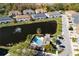Aerial view of home near pond with fountain and community pool with palm trees at 6732 Rocky Park St, Tampa, FL 33625
