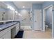 Modern bathroom with a granite countertop sink, glass enclosed shower, and private toilet room at 6732 Rocky Park St, Tampa, FL 33625