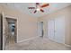 Bedroom with a ceiling fan, access to other rooms, and a large closet at 6732 Rocky Park St, Tampa, FL 33625