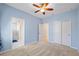 Cozy bedroom with plush carpeting, ceiling fan, and a connected ensuite bathroom at 6732 Rocky Park St, Tampa, FL 33625