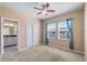 Bedroom featuring a ceiling fan, double windows, large closet, and access to bathroom at 6732 Rocky Park St, Tampa, FL 33625