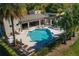 Community pool with lounge chairs and tables with palm trees around the area at 6732 Rocky Park St, Tampa, FL 33625