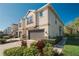 Stylish townhome featuring a stucco exterior, manicured landscaping, and attached two-car garage at 6732 Rocky Park St, Tampa, FL 33625