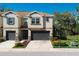 Beautiful two-story townhome with a well-maintained lawn, mature trees, and a two car garage at 6732 Rocky Park St, Tampa, FL 33625
