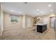 Open kitchen area with a central island, dark cabinets, and stainless steel refrigerator next to the living space at 6732 Rocky Park St, Tampa, FL 33625