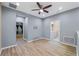 Versatile living area with wood-look flooring, providing access to other rooms and laundry at 6732 Rocky Park St, Tampa, FL 33625