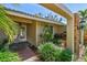 Charming front entrance with a brick walkway, lush landscaping, and covered entryway at 706 Citrus Ct, Largo, FL 33770