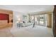 Bright living room features neutral carpet, sliding doors to the lanai and access to the dining room at 706 Citrus Ct, Largo, FL 33770