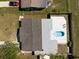 Overhead view of a home with a backyard featuring a patio area, a small pool, and a fenced perimeter at 7322 Mako Dr, Hudson, FL 34667