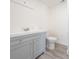 Clean bathroom features a sleek vanity with brushed nickel hardware and a modern toilet at 7322 Mako Dr, Hudson, FL 34667