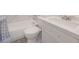 Bathroom featuring a tub with marble-like tiling and modern vanity at 7322 Mako Dr, Hudson, FL 34667