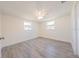 Bedroom with modern gray floors, ceiling fan and natural light at 7322 Mako Dr, Hudson, FL 34667