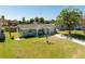 Charming single-story home with a well-maintained lawn, mature trees, and inviting curb appeal at 7322 Mako Dr, Hudson, FL 34667