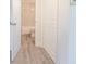 Hallway leading to bathroom with gray floor at 7322 Mako Dr, Hudson, FL 34667
