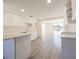 Well lit kitchen with white cabinets, tile backsplash and sleek flooring throughout at 7322 Mako Dr, Hudson, FL 34667
