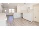 Bright modern kitchen with white cabinets, countertops and gray floors at 7322 Mako Dr, Hudson, FL 34667