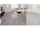 Living room with white sofa, modern decor, hardwood floors, and kitchen island at 7322 Mako Dr, Hudson, FL 34667