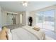 A spacious main bedroom features a sliding barn door to the bathroom and large glass doors out to the pool at 7322 Mako Dr, Hudson, FL 34667