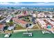 Panoramic aerial view of waterfront condos, a pool, a dock, and tranquil bay waters at 8711 Blind Pass Rd # 207A, St Petersburg, FL 33706