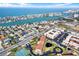 This aerial view shows the condos, a pond, and the community's layout in relation to the beach at 8711 Blind Pass Rd # 207A, St Petersburg, FL 33706