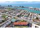 Breathtaking aerial view of a coastal community with lush landscaping and waterfront access to the tranquil bay at 8711 Blind Pass Rd # 207A, St Petersburg, FL 33706