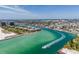 Scenic aerial view of waterfront condos along the inter coastal with boat traffic and sandy beaches at 8711 Blind Pass Rd # 207A, St Petersburg, FL 33706