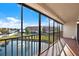 Screened balcony with water views and railing overlooking water feature at 8711 Blind Pass Rd # 207A, St Petersburg, FL 33706
