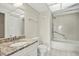Bright bathroom with tile floors, granite vanity, and shower-tub combination at 8711 Blind Pass Rd # 207A, St Petersburg, FL 33706