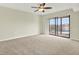 Inviting bedroom featuring plush carpeting and sliding glass doors leading to a private balcony with views at 8711 Blind Pass Rd # 207A, St Petersburg, FL 33706