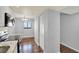 View of the kitchen leading into the dining area with hardwood floors at 8711 Blind Pass Rd # 207A, St Petersburg, FL 33706