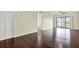Bright living room featuring hardwood floors, a ceiling fan, and sliding glass doors at 8711 Blind Pass Rd # 207A, St Petersburg, FL 33706