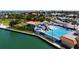 Aerial view of a community pool with slides, a splash pad, and lane-divided swimming area at 8711 Blind Pass Rd # 207A, St Petersburg, FL 33706