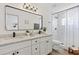 Modern bathroom with double vanity, sleek fixtures, and walk-in shower with tile surround at 9203 Hollyridge Pl, Temple Terrace, FL 33637