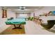 Entertaining game room featuring pool tables, comfortable seating, and natural light at 9815 47Th N Ave # 306, St Petersburg, FL 33708