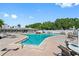 Community outdoor pool and lounge area with well maintained landscaping and outdoor furniture at 9815 47Th N Ave # 306, St Petersburg, FL 33708