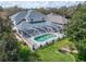 Aerial view highlighting the screened pool, patio, and the surrounding greenery at 10220 Deercliff Dr, Tampa, FL 33647