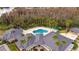 Aerial view of clubhouse with pool, lounge chairs, and palm trees at 10220 Deercliff Dr, Tampa, FL 33647